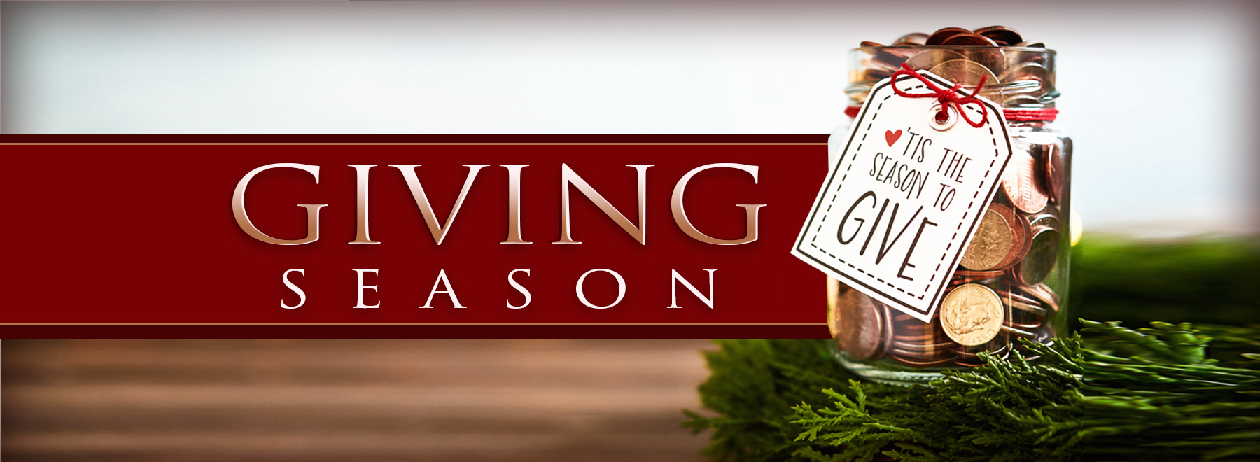 A jar full of coins with tag that says "Tis the season for giving"